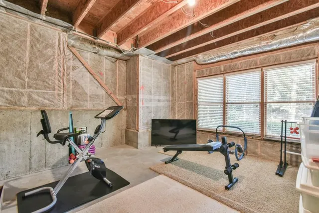 a backyard with chairs and large trees