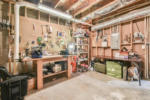 a view of very nice looking house with a large windows plants and large trees