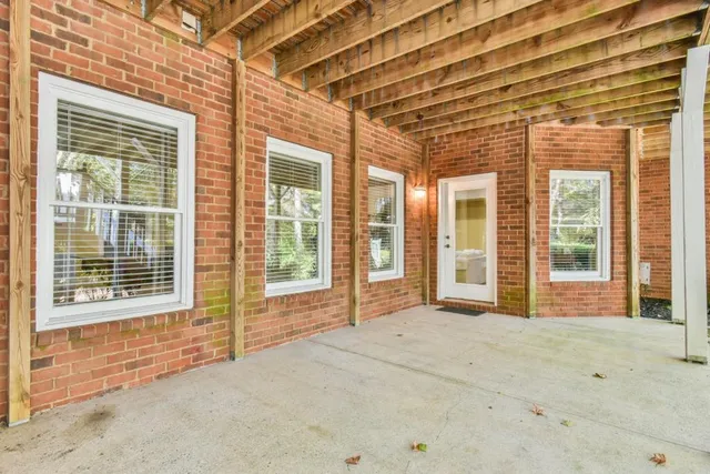 a view of a yard with plants and trees
