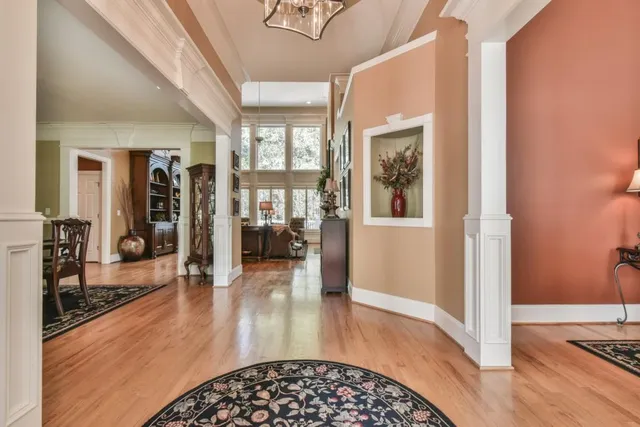 a living room with furniture fireplace and large windows