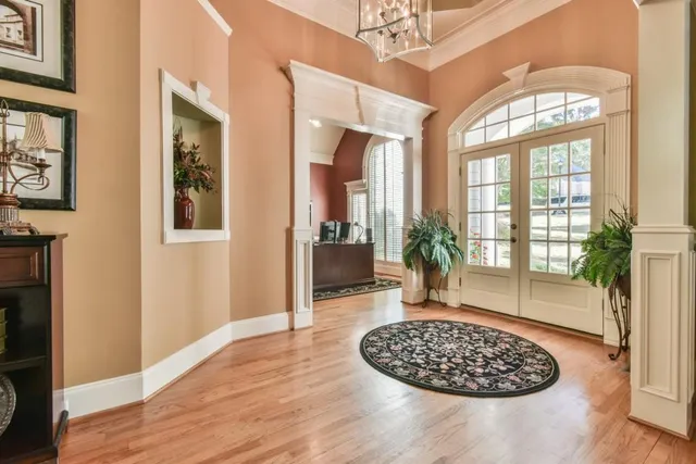 a bedroom with furniture and a large window