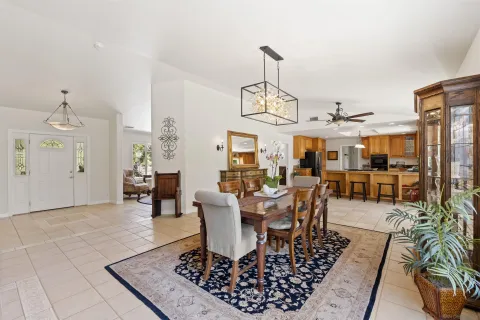 a kitchen with stainless steel appliances granite countertop sink stove refrigerator and cabinets