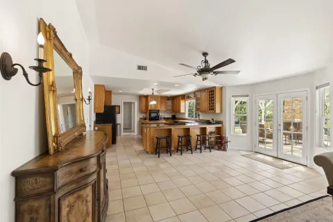 a view of a living room and kitchen with wooden floor