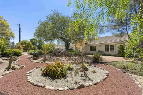 a front view of a house with a garden