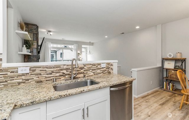 a kitchen with a sink and a refrigerator
