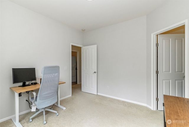 a view of a workspace with furniture and wooden floor