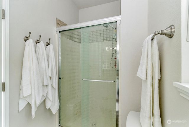 a bathroom with a shower and a sink