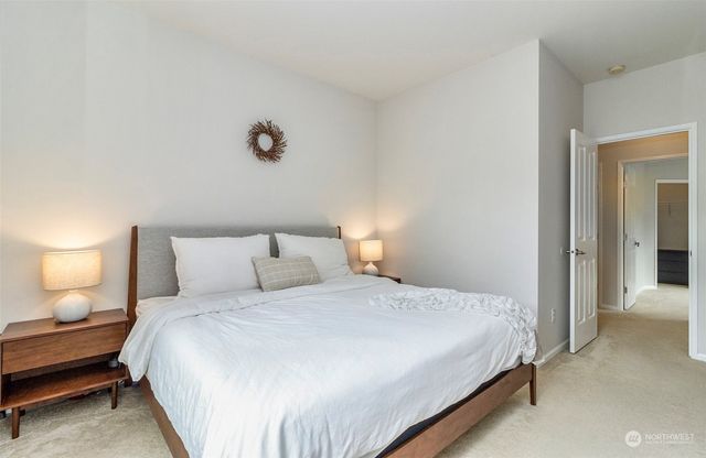 a bedroom with a bed and a night stand