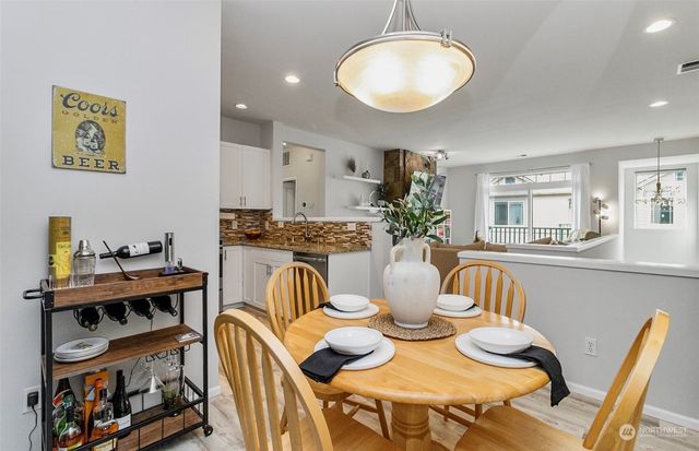 a view of a dining room with furniture and a potted plant
