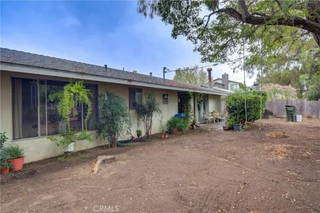 an aerial view of a house with a yard and trees