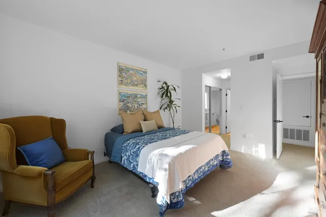 a bedroom with a bed and couch