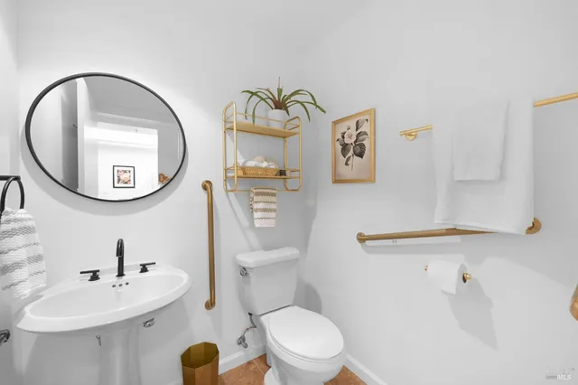 a bathroom with a toilet a sink and a mirror