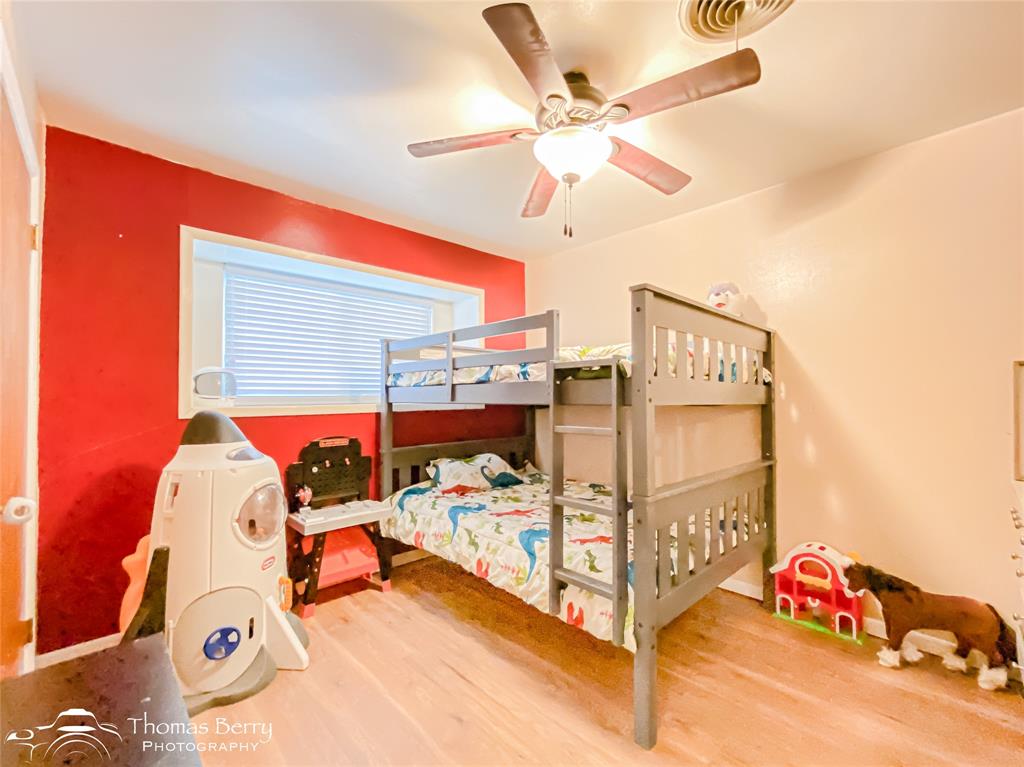 1104 Hickory Street Roscoe, TX 79545 - Photo 13 of 22 Bedroom with wood finished floors and a ceiling fan