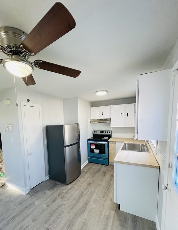 105-107 Parallel Street Springfield, MA 01104 - Photo 4 of 15 a kitchen with a refrigerator and a stove top oven