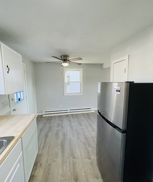 105-107 Parallel Street Springfield, MA 01104 - Photo 8 of 15 a view of a kitchen with a sink and refrigerator