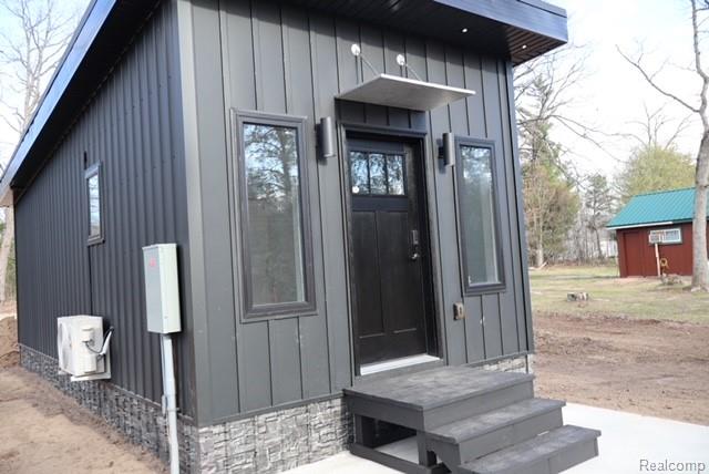 1545 South La Chance Road Lake City, MI 49651 - Photo 24 of 51 Doorway to property featuring board and batten siding