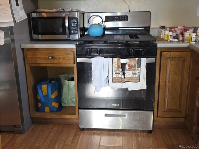 a stove top oven sitting inside of a kitchen