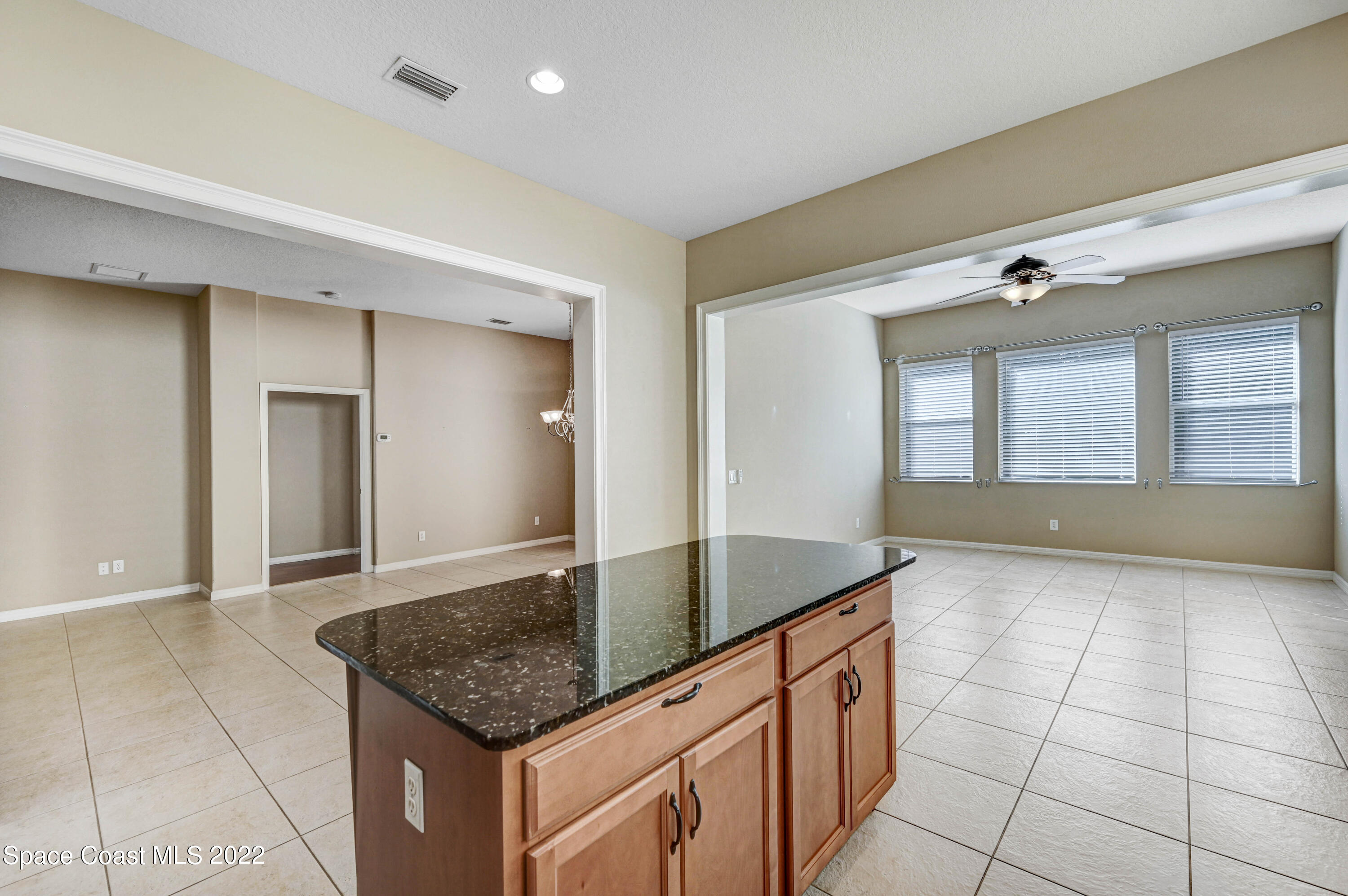 2077 Elkins Point Melbourne, FL 32935 - Photo 11 of 31 a kitchen with granite countertop a sink and cabinets