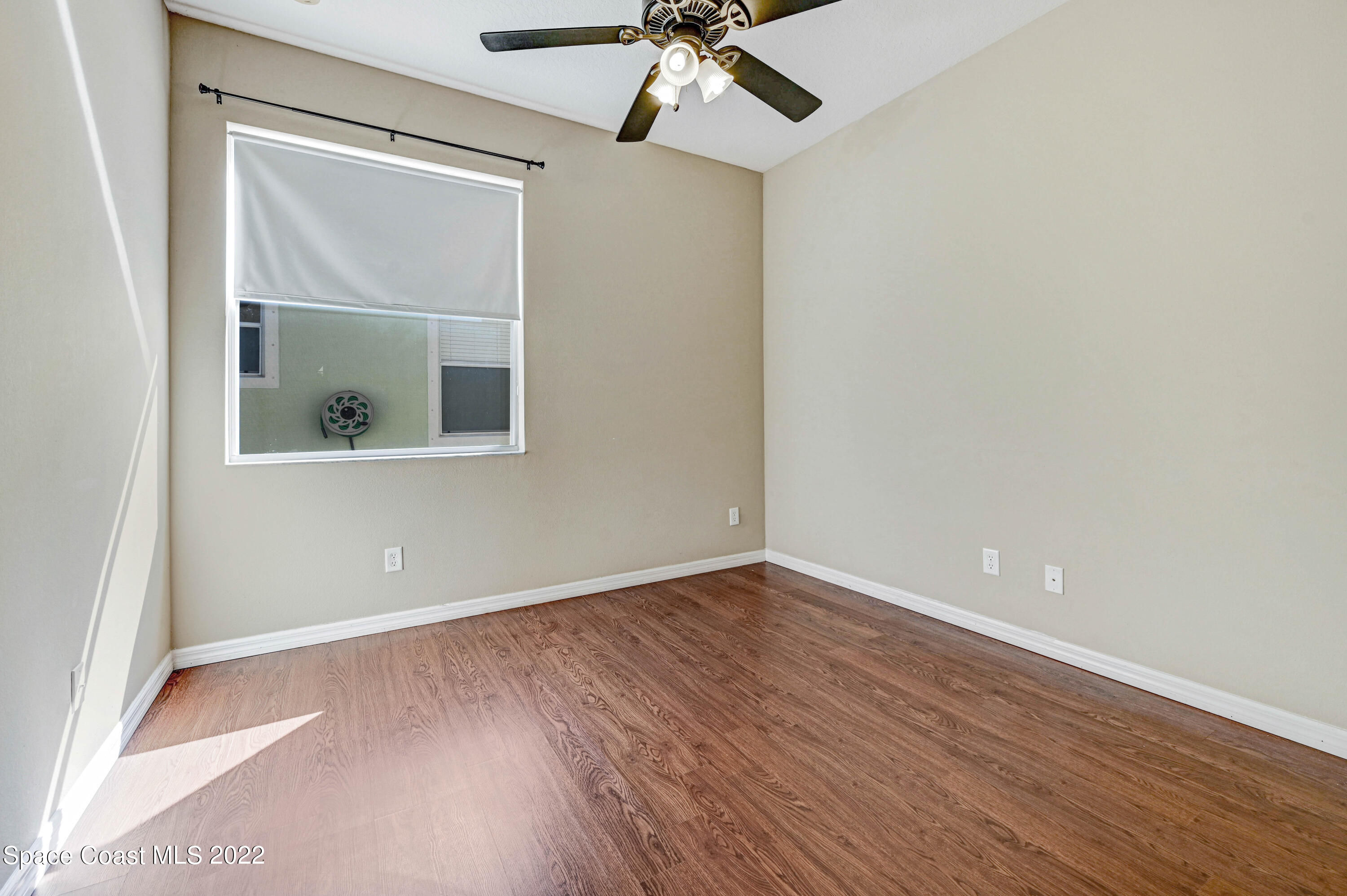 2077 Elkins Point Melbourne, FL 32935 - Photo 19 of 31 a view of an empty room with wooden floor and a window