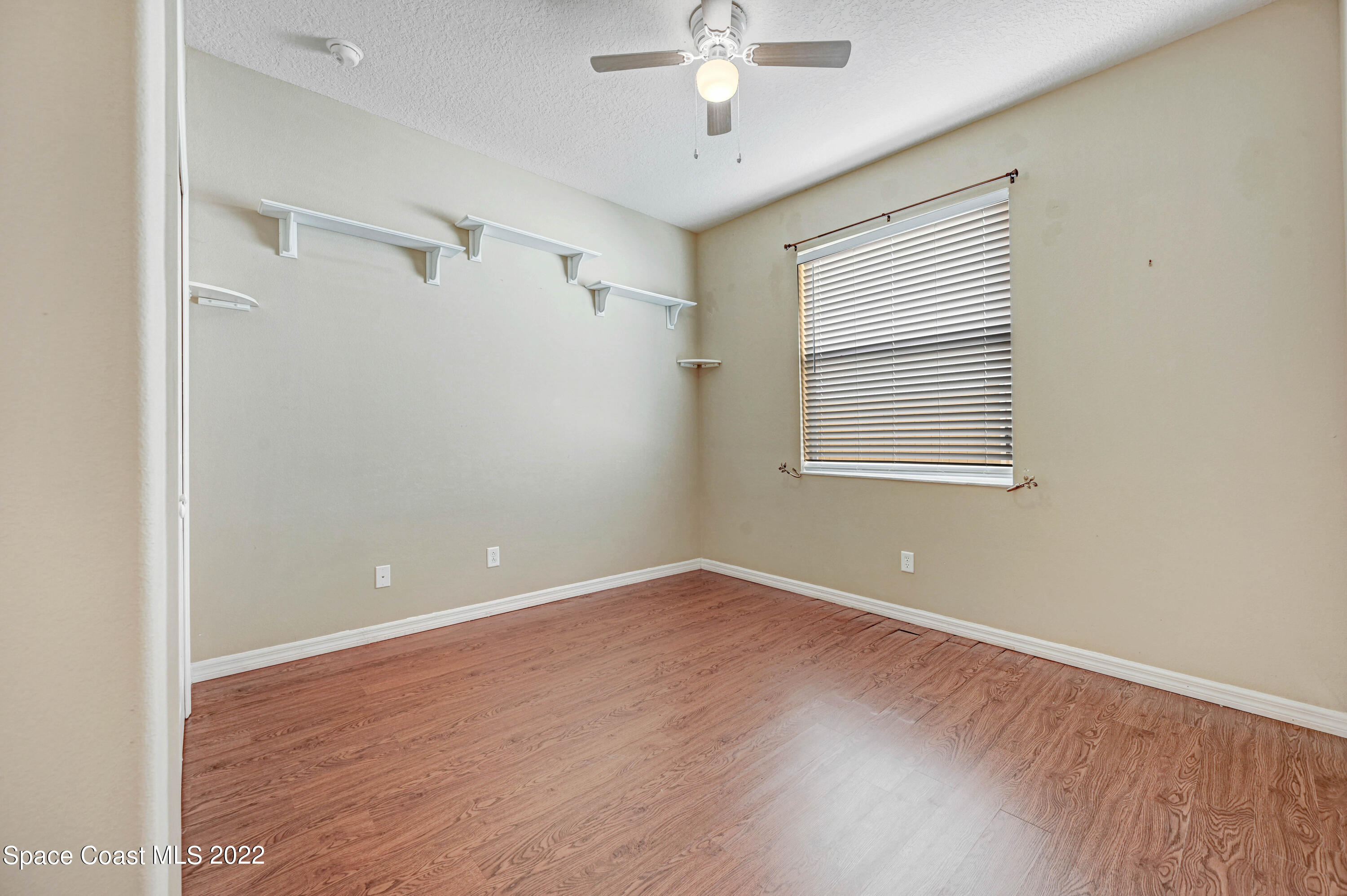 2077 Elkins Point Melbourne, FL 32935 - Photo 20 of 31 a view of an empty room with a window and wooden floor