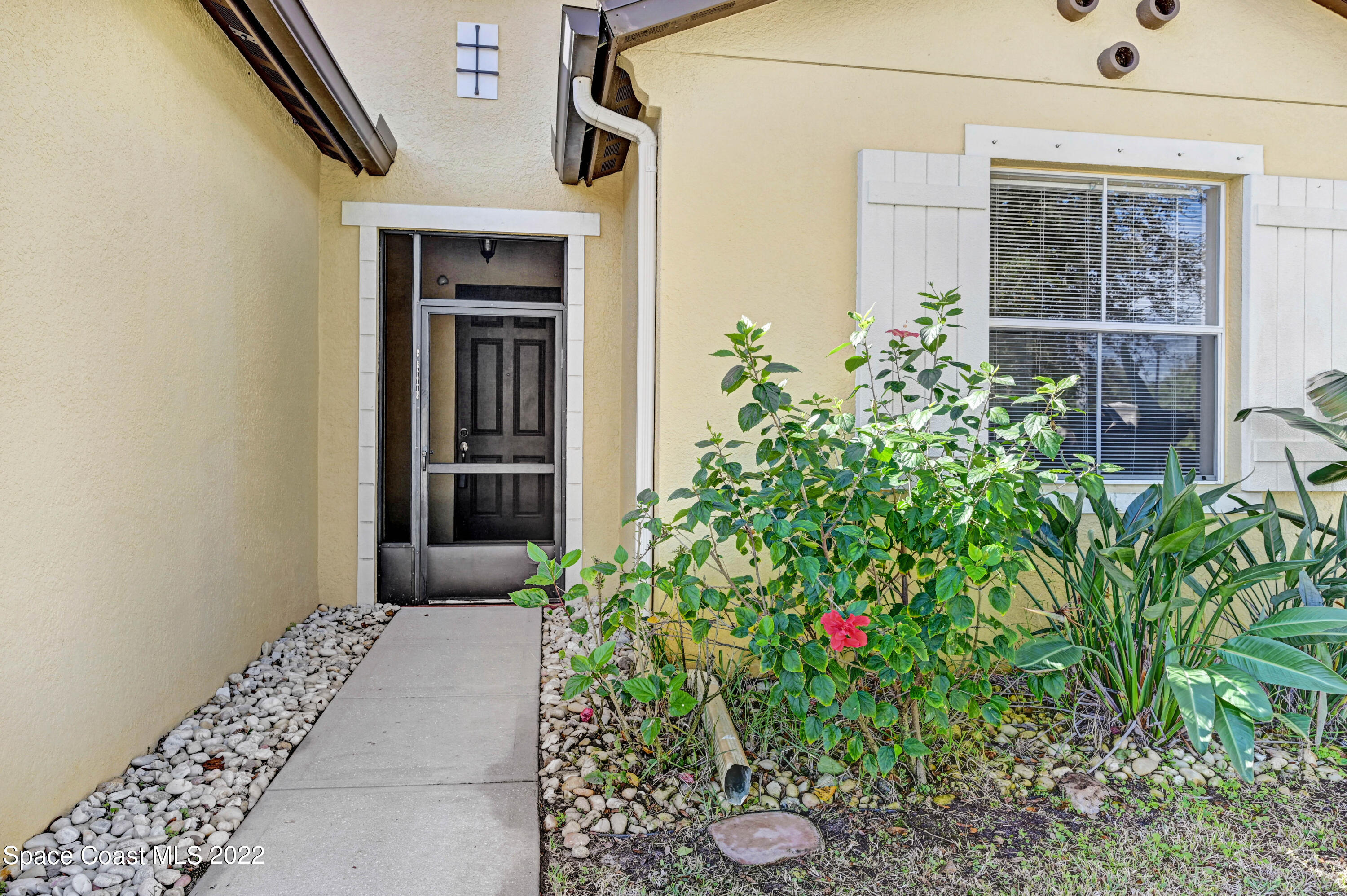 2077 Elkins Point Melbourne, FL 32935 - Photo 2 of 31 a front view of a house with a yard