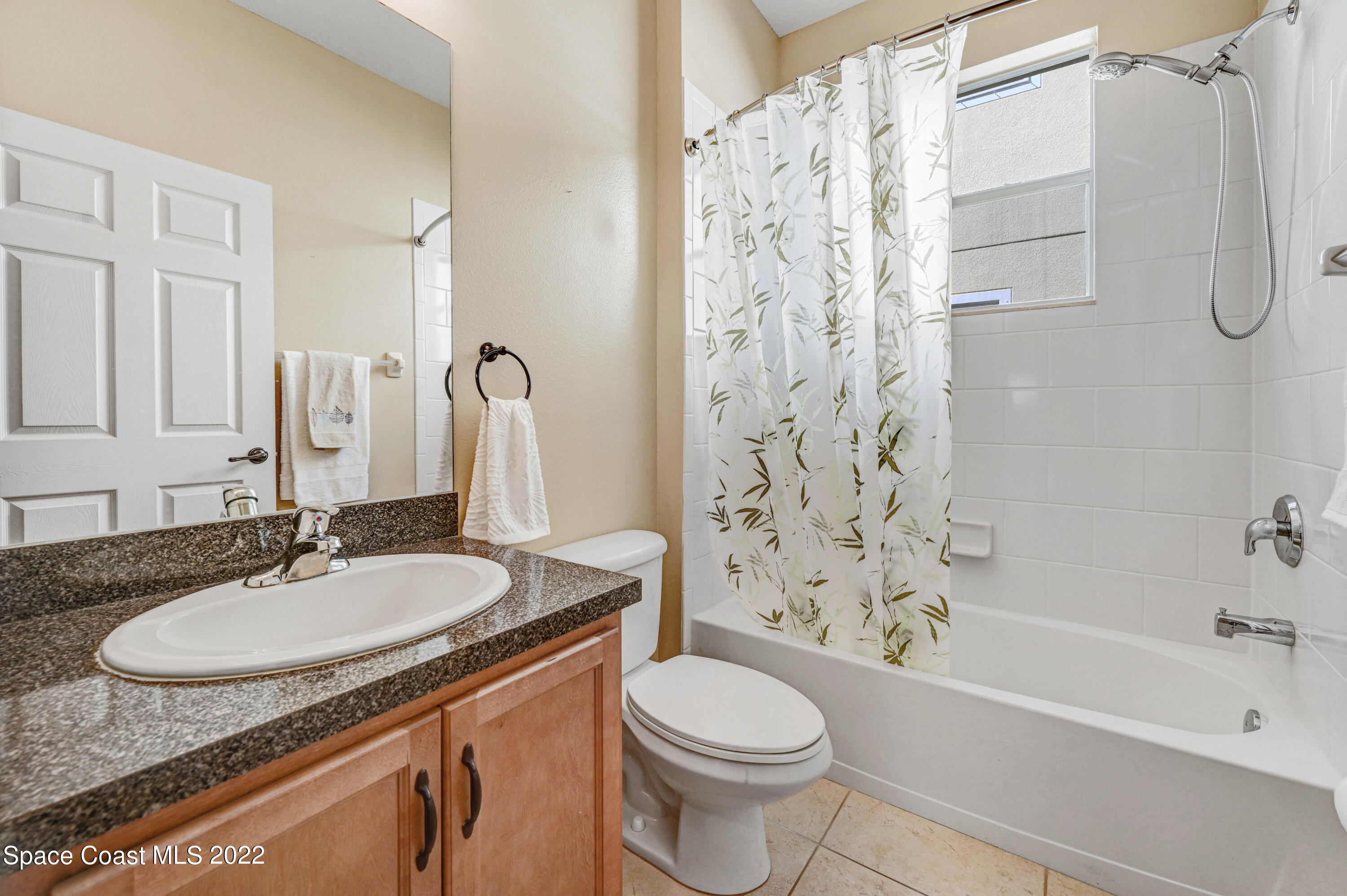 2077 Elkins Point Melbourne, FL 32935 - Photo 21 of 31 a bathroom with a granite countertop sink toilet and shower