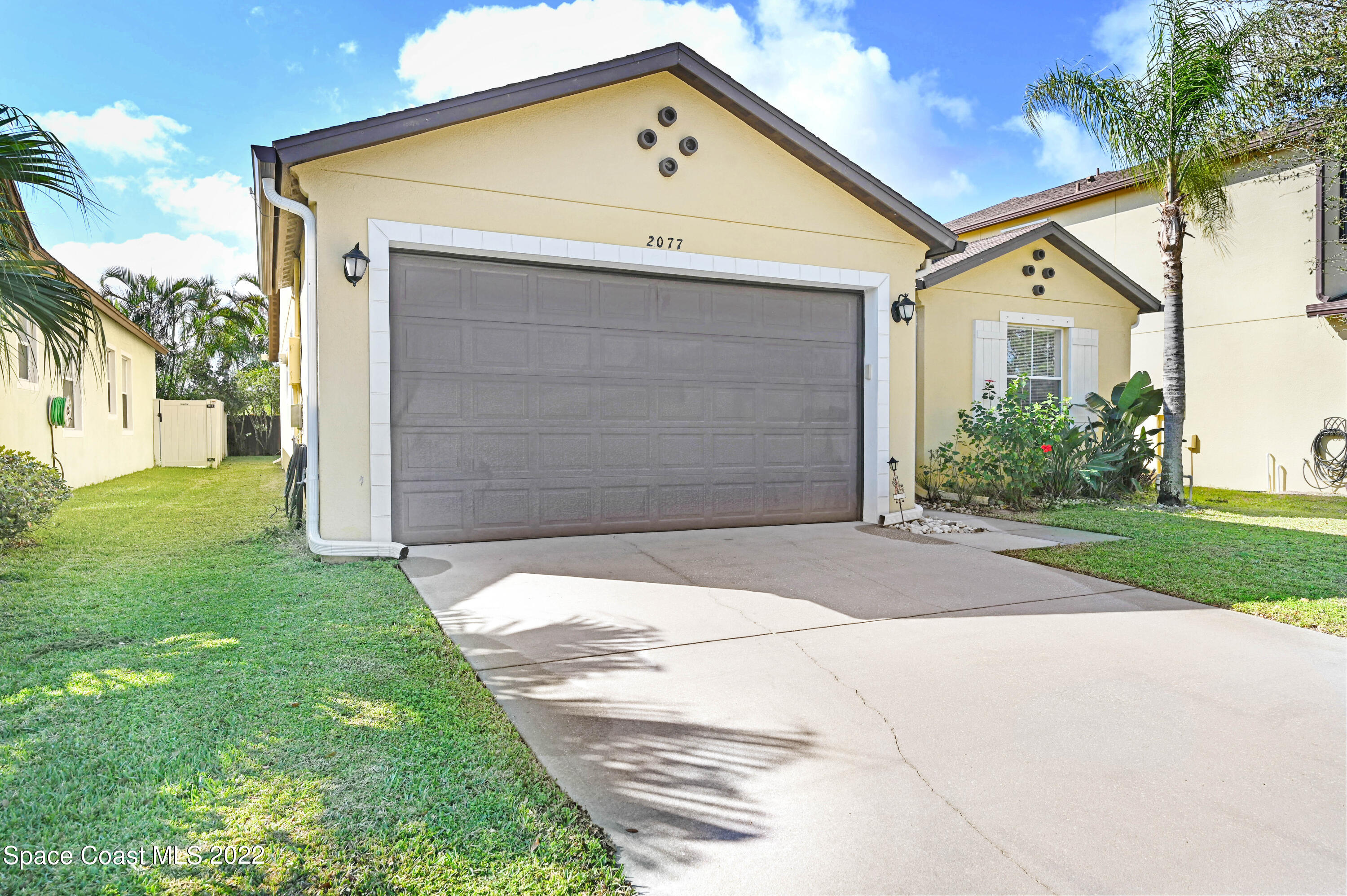 2077 Elkins Point Melbourne, FL 32935 - Photo 30 of 31 a front view of a house with a yard and garage