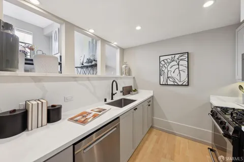 a kitchen that has a sink and a stove in it