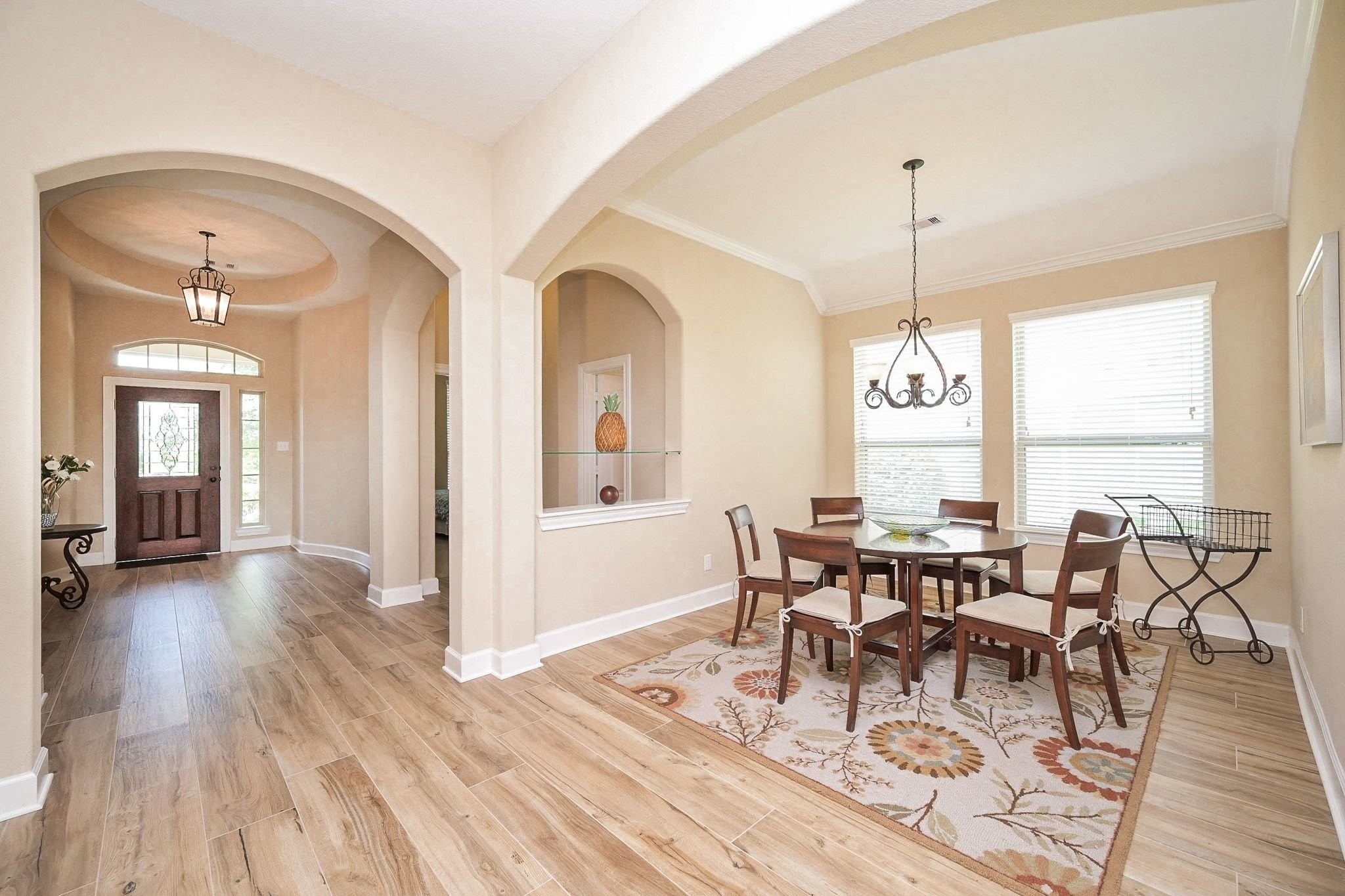 107 North Bacopa Drive Spring, TX 77389 - Photo 7 of 34 Long, open hallway with elegant archways and high ceilings, creating a smooth flow toward the heart of the home.