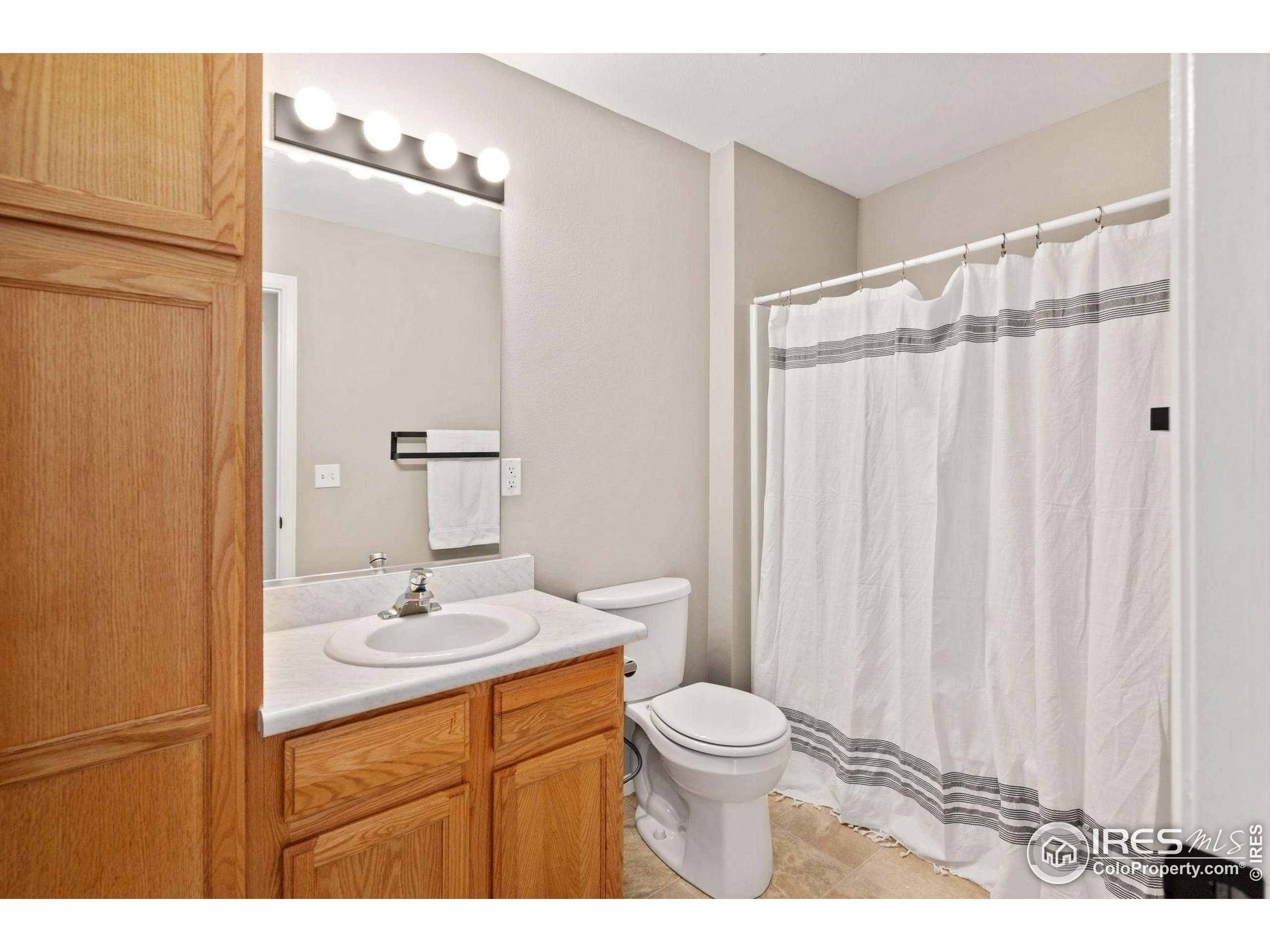 1021 Rolland Moore Drive, Unit F Fort Collins, CO 80526 - Photo 19 of 29 a bathroom with a sink a toilet and shower
