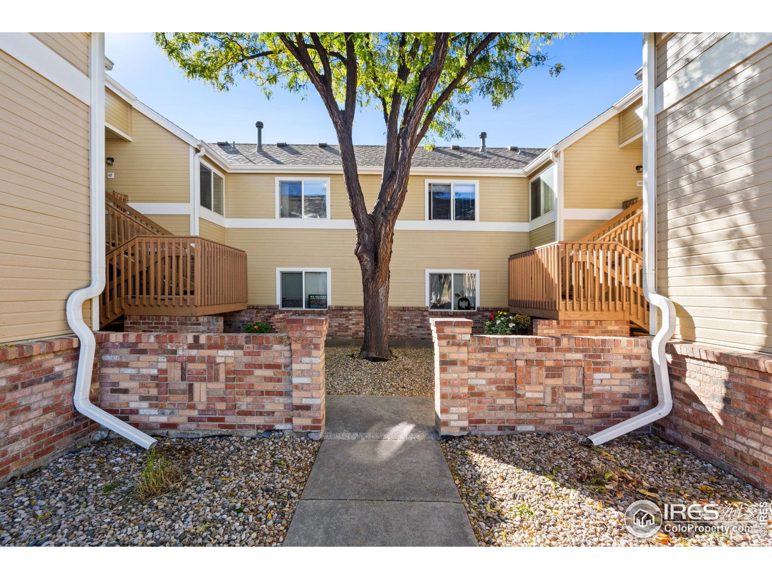 1021 Rolland Moore Drive, Unit F Fort Collins, CO 80526 - Photo 2 of 29 a view of a patio with table and chairs next to a yard