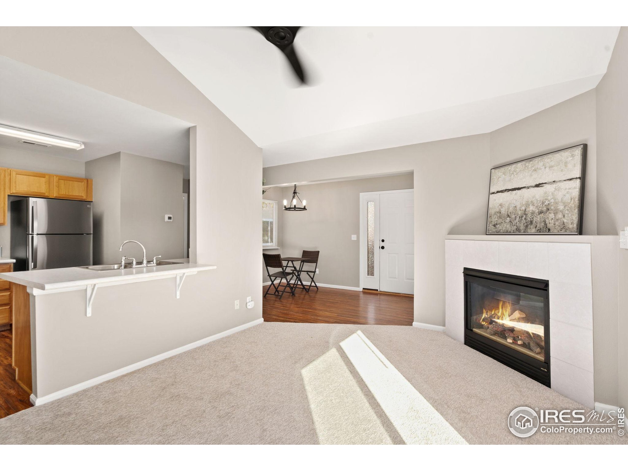 1021 Rolland Moore Drive, Unit F Fort Collins, CO 80526 - Photo 8 of 29 a living room with furniture and a fireplace