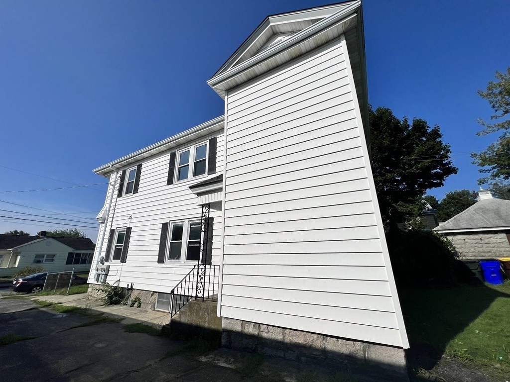 1590 Slade Street Fall River, MA 02721 - Photo 3 of 35 a view of a white house with a yard