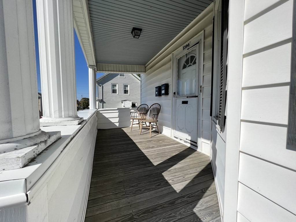 1590 Slade Street Fall River, MA 02721 - Photo 4 of 35 a hallway with white cabinets and wooden floor