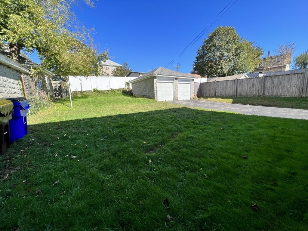 1590 Slade Street Fall River, MA 02721 - Photo 10 of 35 a view of a white house with a big yard and a large tree