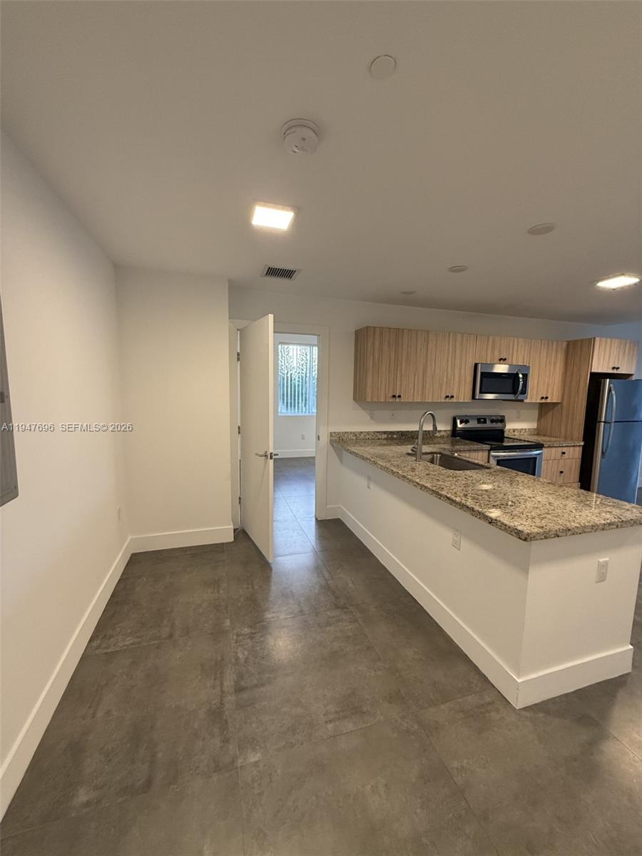 2010 Southwest 25th Terrace, Unit 302 Miami, FL 33133 - Photo 6 of 16 a view of kitchen with granite countertop lots of white cabinets