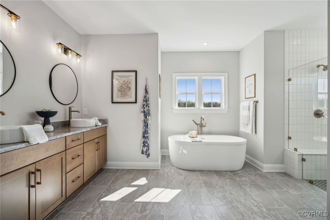 16873 Watchman Way Beaverdam, VA 23015 - Photo 19 of 40 a spacious bathroom with a double vanity sink mirror and a bathtub