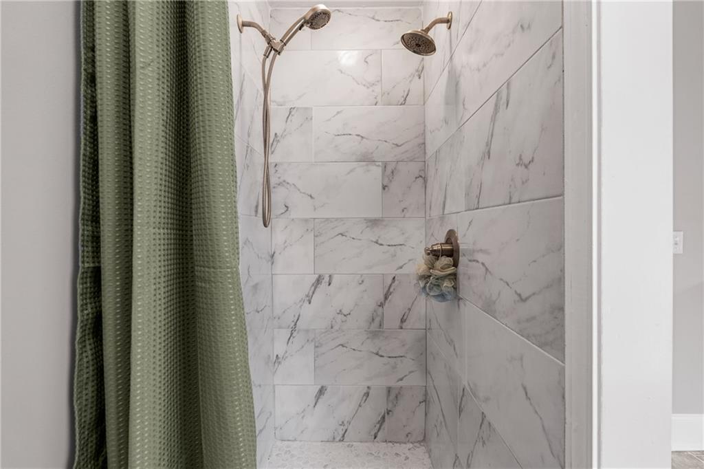 1449 Cummings Road Smiths Station, AL 36877 - Photo 23 of 28 White tile shower surround with bronze fixtures and a rainfall shower head