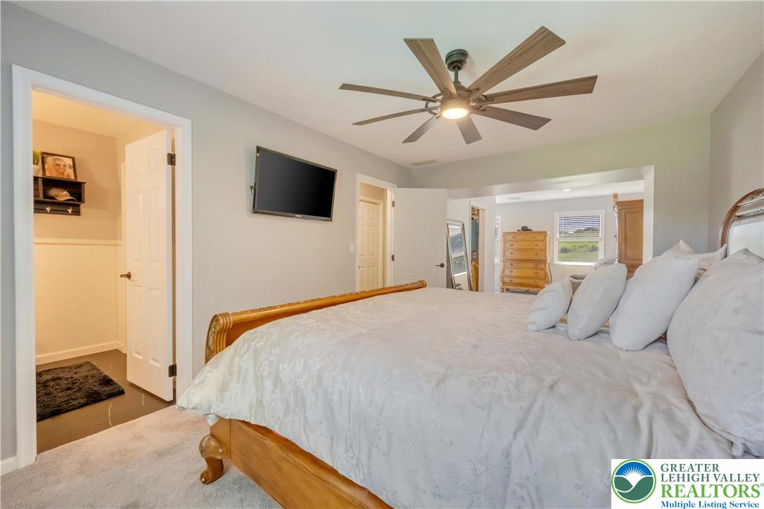 2448 Keeler Road Bath, PA 18014 - Photo 27 of 37 Relax in this well-lit bedroom featuring soft carpeting and an overhead ceiling fan.