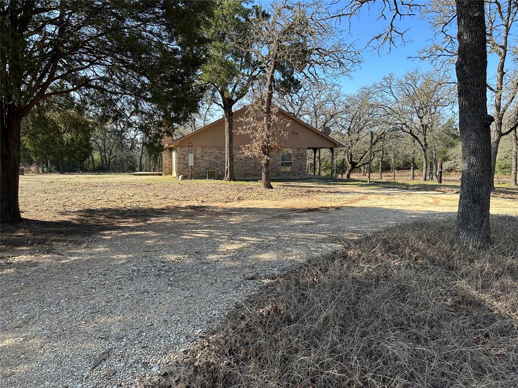 1047 Pr 3022 Elgin Elgin, TX 78621 - Photo 17 of 21 View of home's exterior with brick siding and driveway