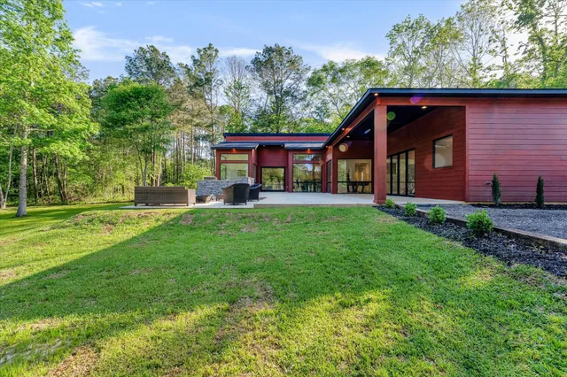 a backyard of a house with table and chairs