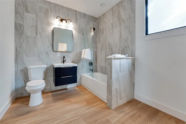 a bathroom with a sink a bathtub and a mirror