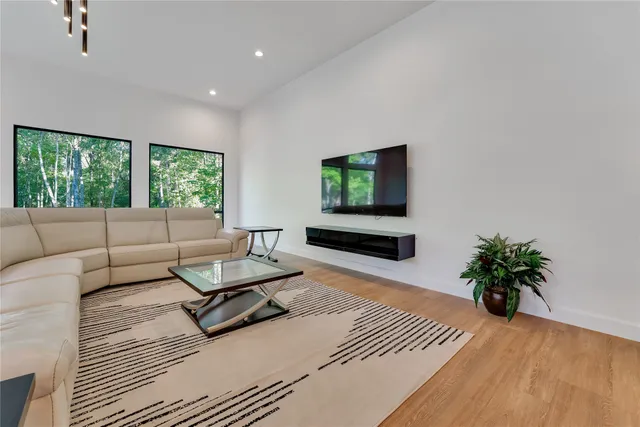 a kitchen with stainless steel appliances a dining table chairs microwave and sink