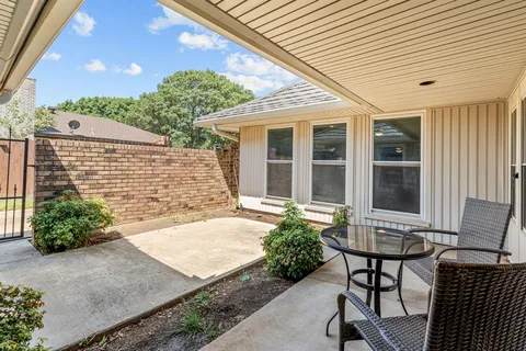 a front view of a house with sitting area