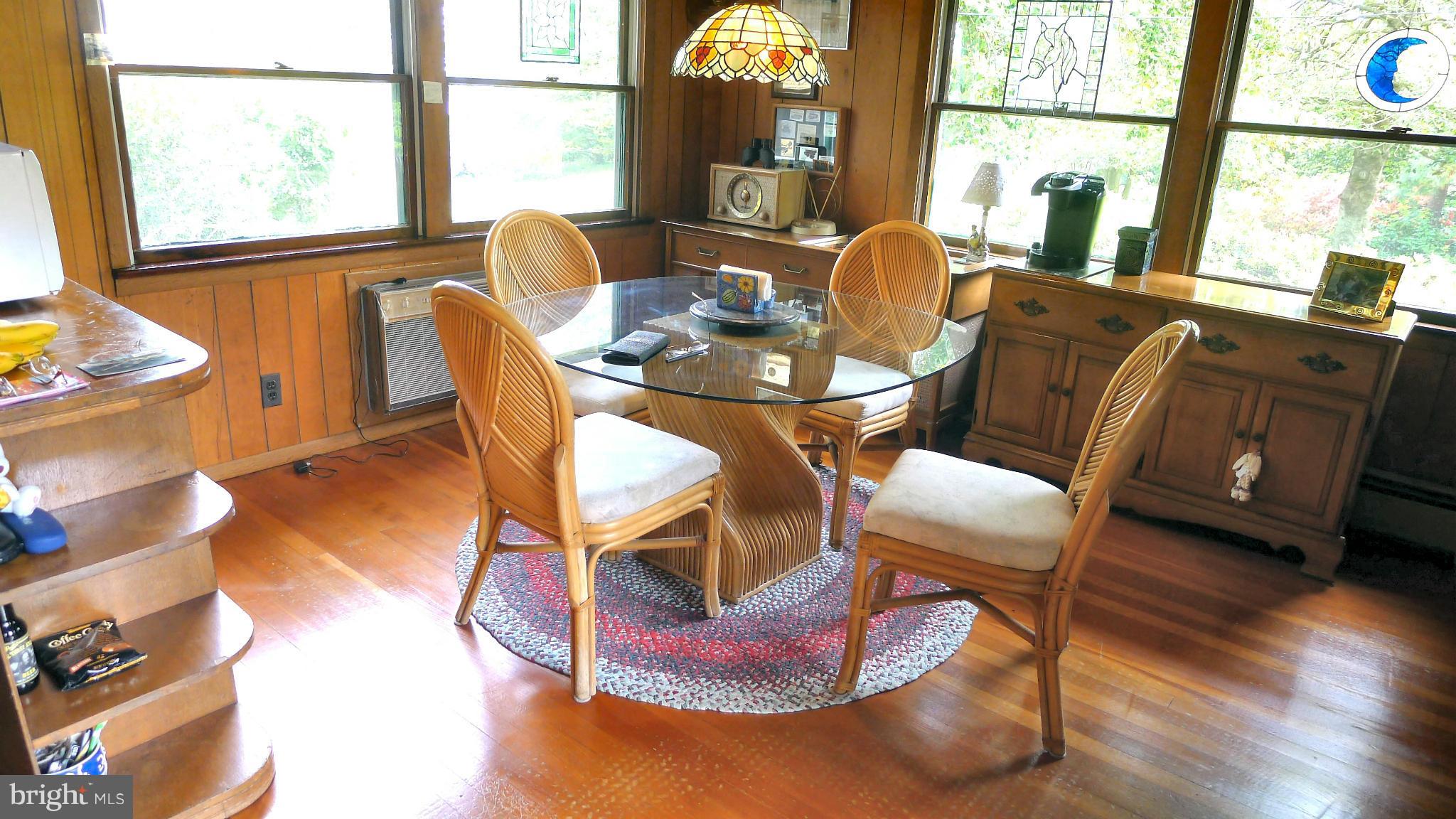 2465 Althea Road Port Republic, MD 20676 - Photo 3 of 4 a dining room with furniture a rug wooden floor and a window