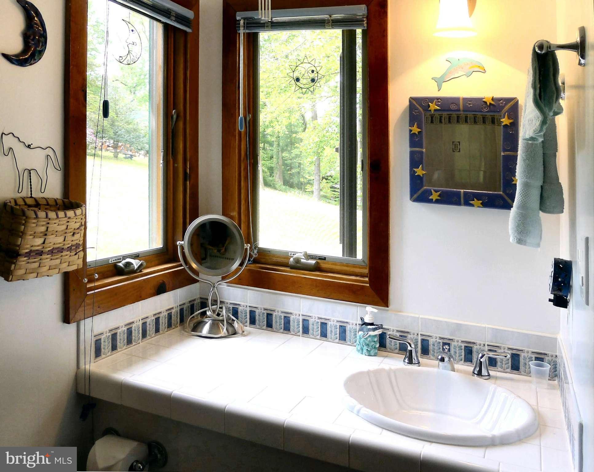 2465 Althea Road Port Republic, MD 20676 - Photo 4 of 4 a bathroom with a sink a mirror and a window