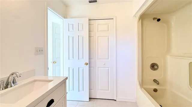 a bathroom with a sink a shower and a mirror