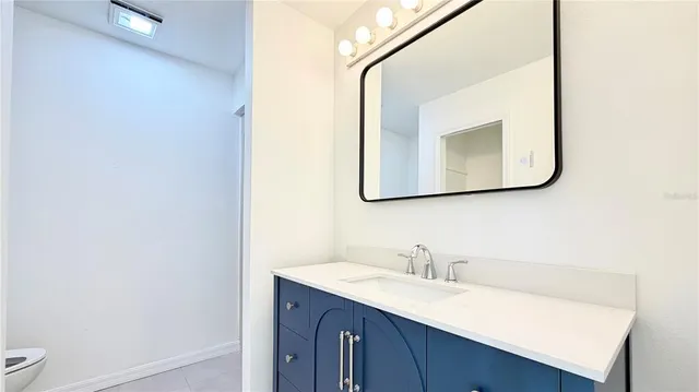 a bathroom with a sink vanity and a mirror