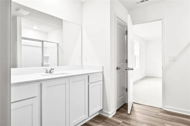a bathroom with a double vanity sink and mirror