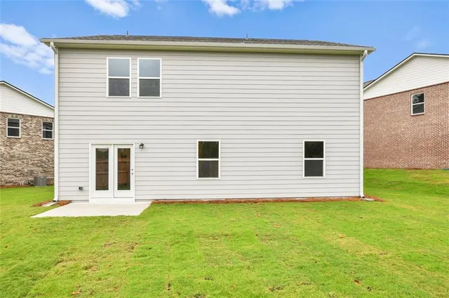 a view of a house with a backyard